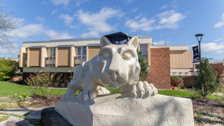 Lion shrine statue with graduation mortarboard